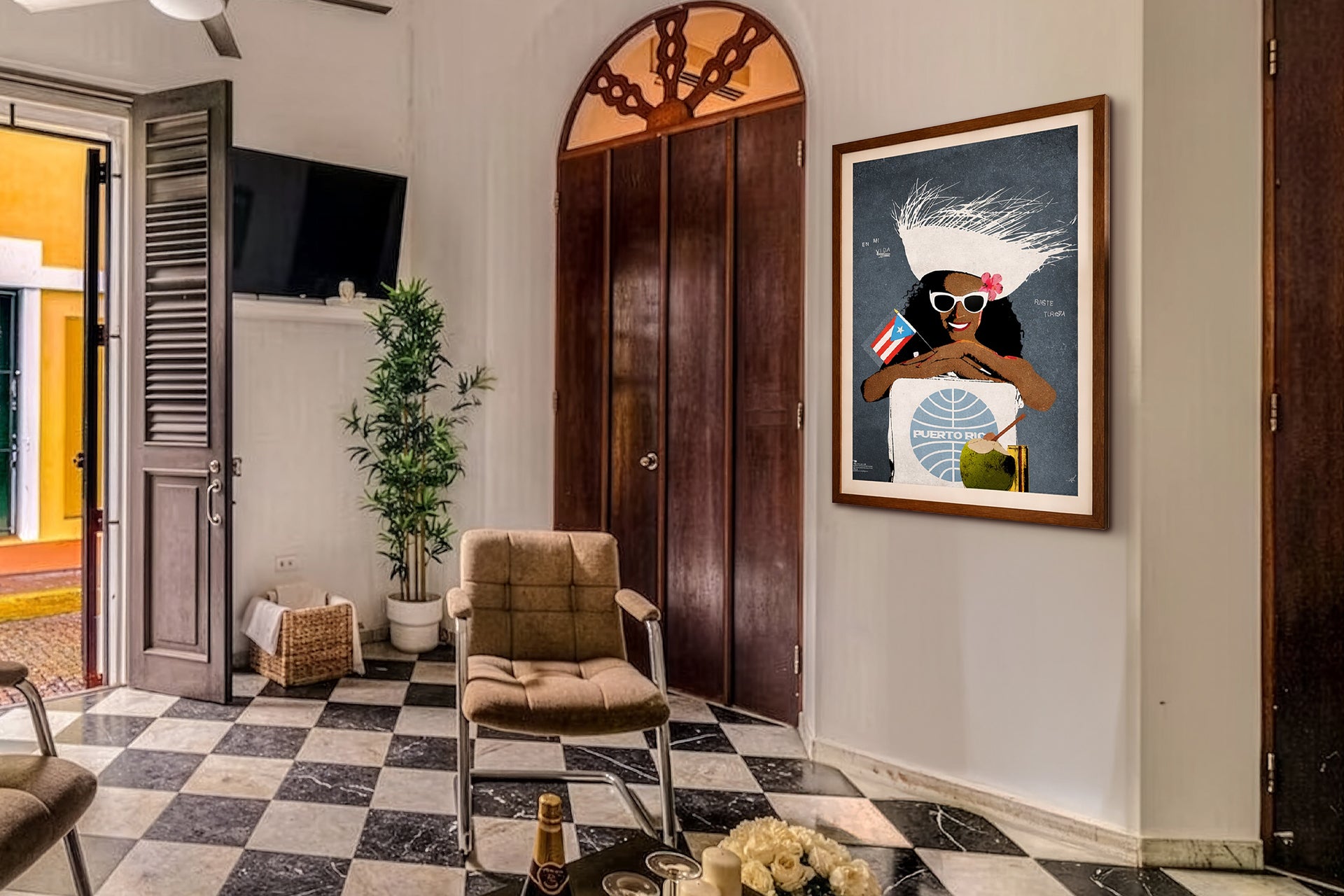 Old San Juan Living room with checkered floor, armchair, and framed Puerto Rican artwork on wall.